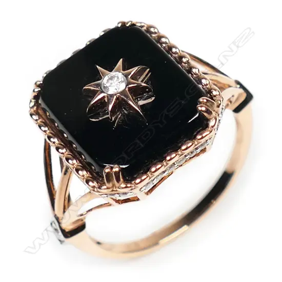 A 14ct rose gold onyx and diamond ring,