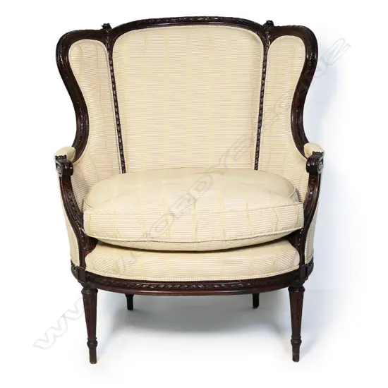 An antique style large French wing back chair,