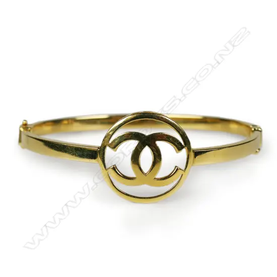 An 18ct yellow gold Chanel hinged bangle,