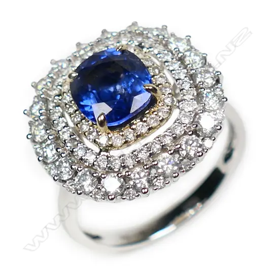 A 14ct white and yellow gold Ceylon sapphire and diamond triple halo ring,