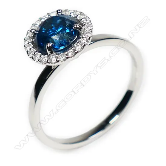 A 14ct white gold blue and white diamond halo ring,