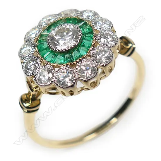 A 14ct gold emerald and diamond halo ring,