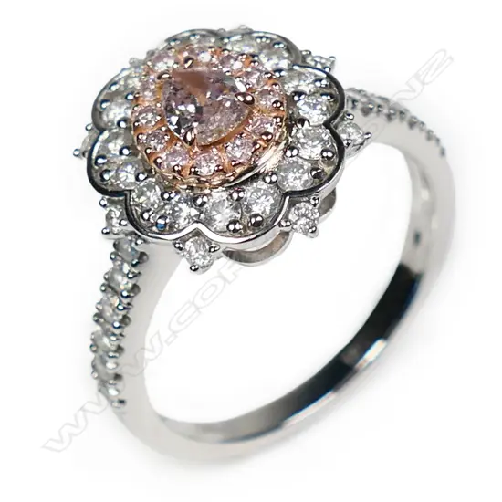 A 14ct white and rose gold pink diamond double halo ring,