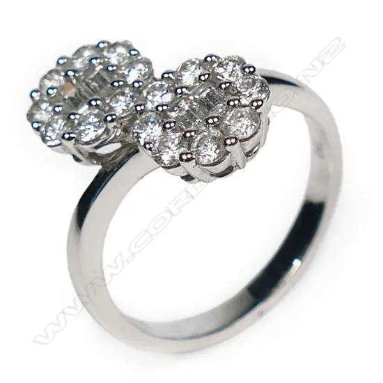 An 18ct white gold and double diamond cluster ring,