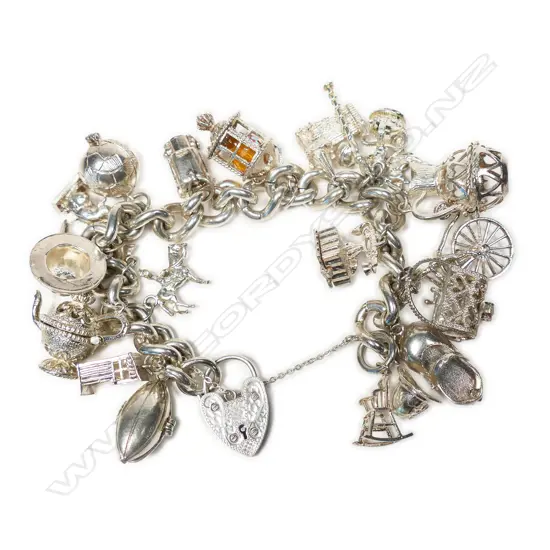 A vintage silver heavy multi charm bracelet,