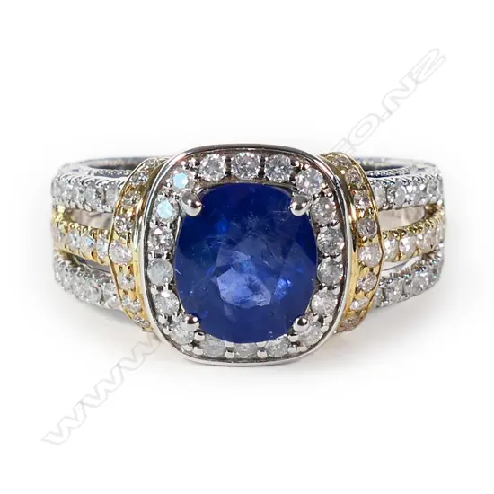 A 14ct yellow and white gold Ceylonese sapphire and diamond halo ring,