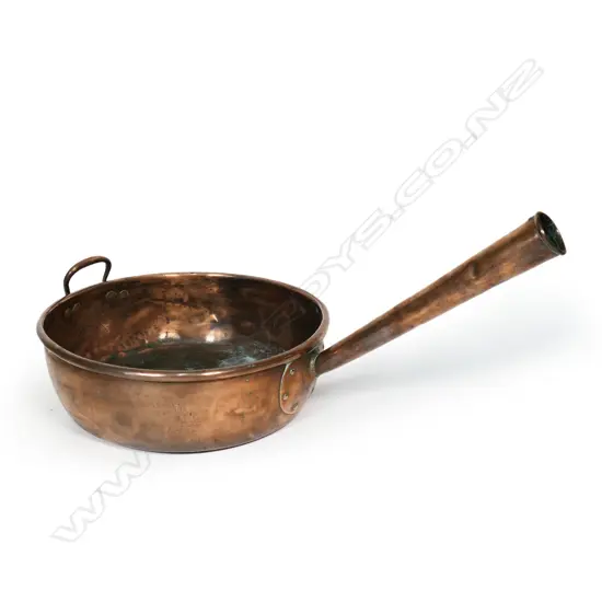 A large old copper pan,