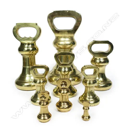 A set of nine graduating brass bell weights,