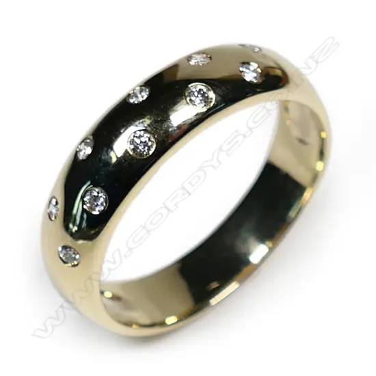 A 9ct yellow gold diamond set band ring,