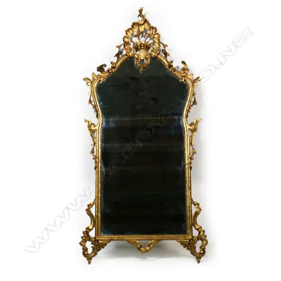 A French style carved giltwood framed elaborate wall mirror,