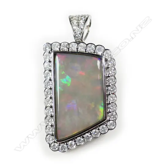 A 14ct white gold opal and diamond pendant,