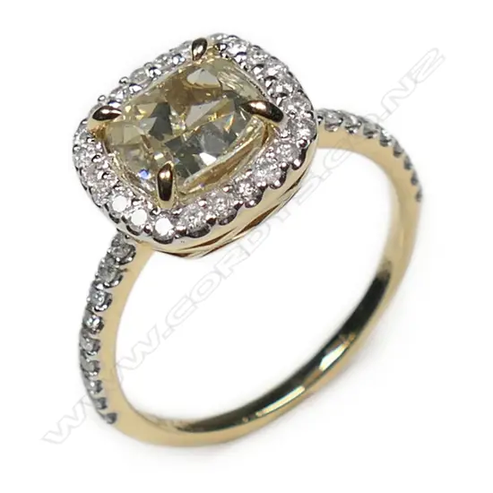 A 14ct gold fancy yellow diamond halo ring,
