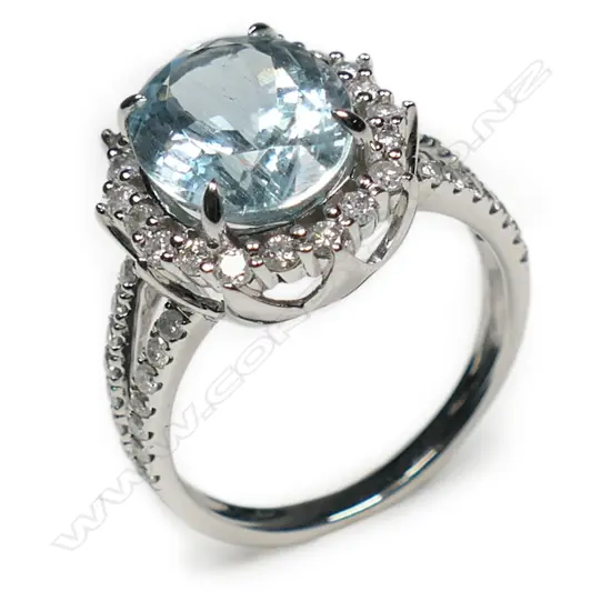 A 14ct white gold aquamarine and diamond halo split band ring,