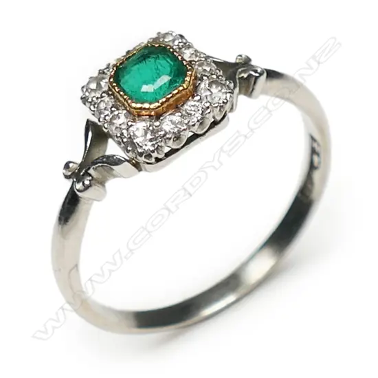 An early 20thC platinum emerald & diamond ring,