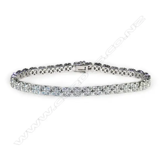 An 18ct white gold and multi diamond tennis type bracelet,