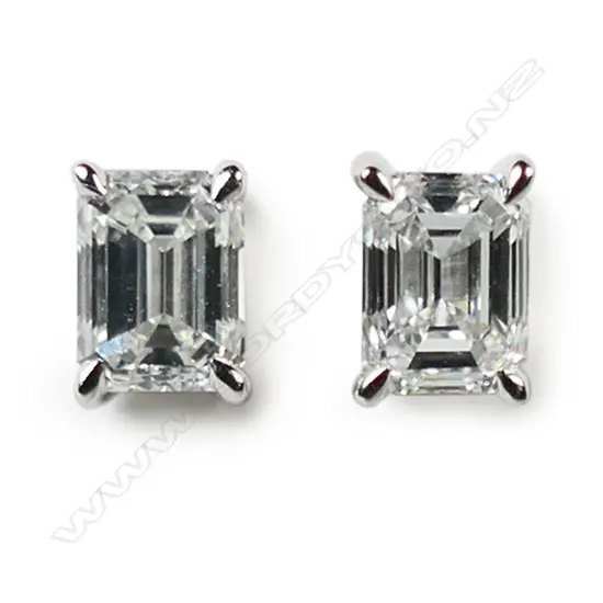 A pair of 18ct white gold and solitaire diamond stud earrings,