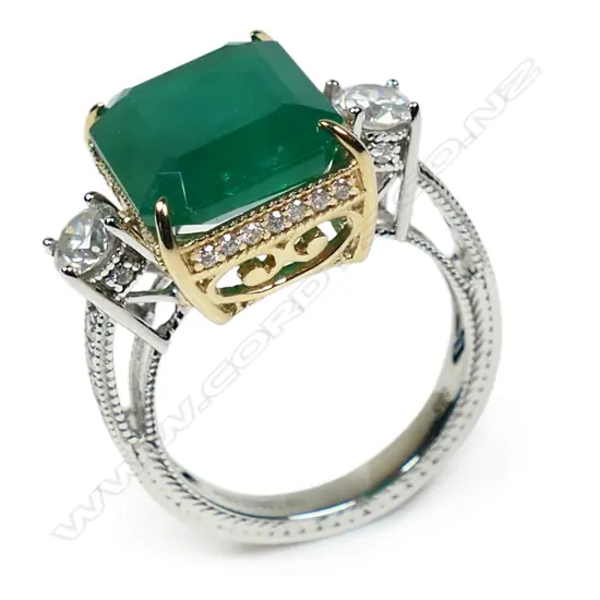 A 14ct white and yellow gold emerald and diamond trilogy ring,