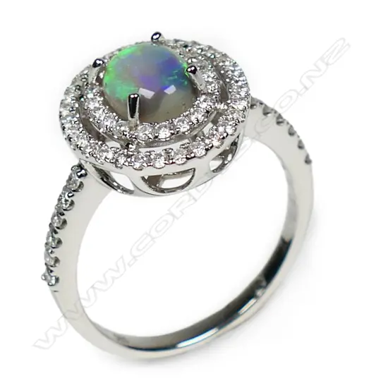 A 14ct white gold opal and diamond double halo ring,
