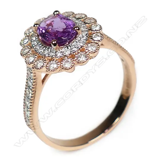 A 14ct rose gold pink sapphire and diamond double halo ring,