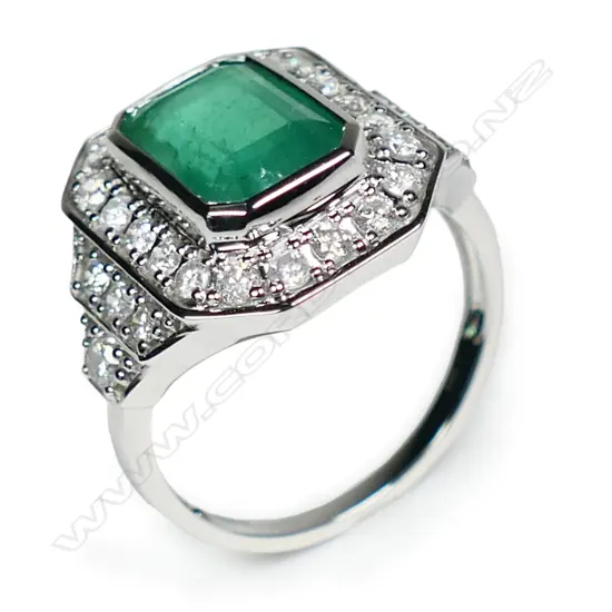A 14ct white gold emerald and diamond ring,