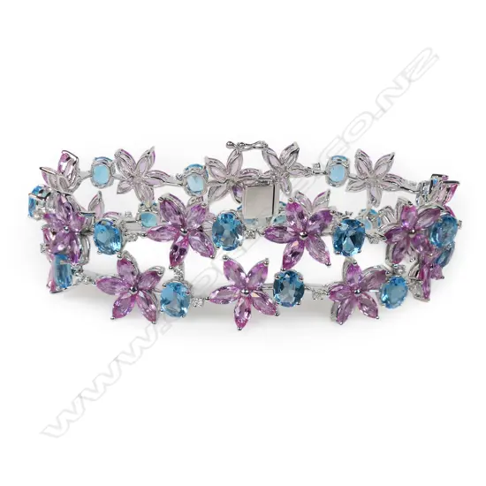 An impressive 18ct white gold diamond, pink sapphire and blue topaz wide bracelet,