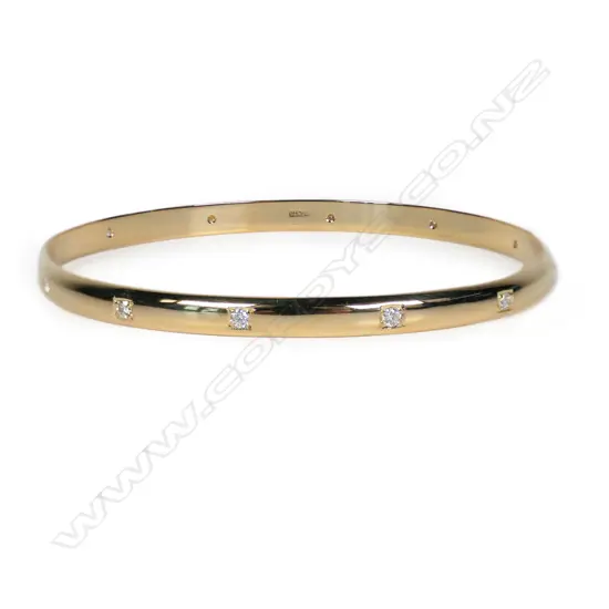 A modern 9ct yellow gold and diamond set bangle,