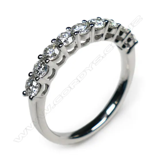 A platinum and diamond band ring,