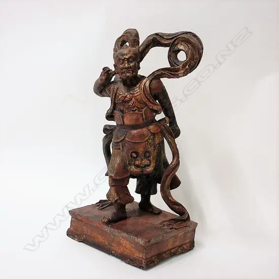A Chinese carved wood lacquered and gilded figure of a demon