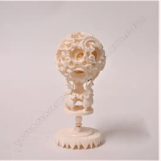 A vintage Chinese carved ivory puzzle ball on elephant stand