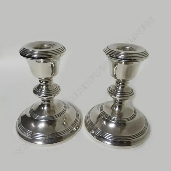 A pair of small silver candlesticks