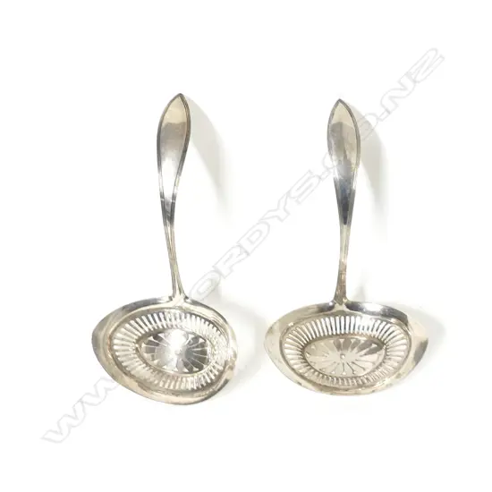 A pair of antique Dutch .833 standard silver sifting ladles