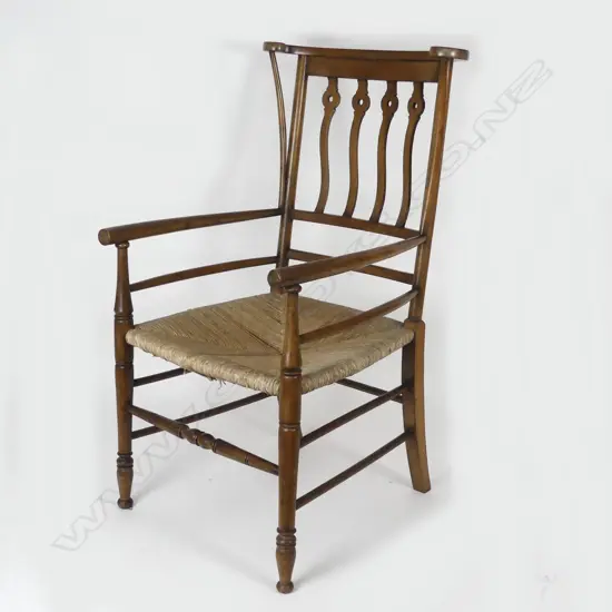 An unusual mahogany Arts & Crafts open elbow chair