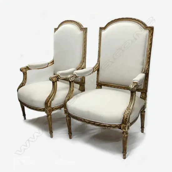 A pair of Italian gilded open elbow armchairs