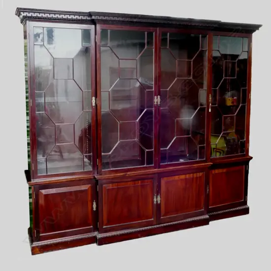 A large and impressive mahogany glazed breakfront bookcase cabinet