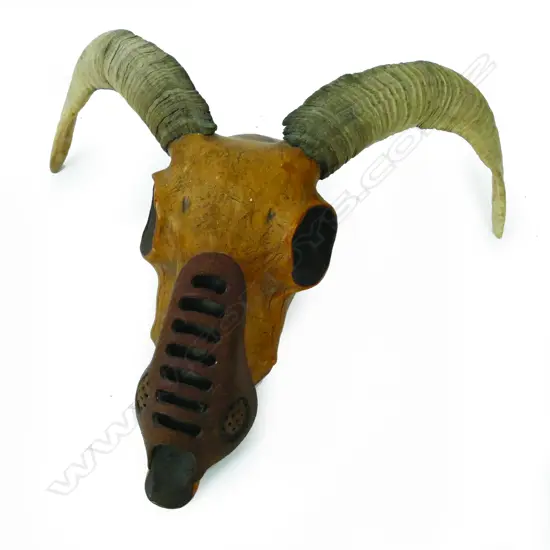A sculpted leather ram skull