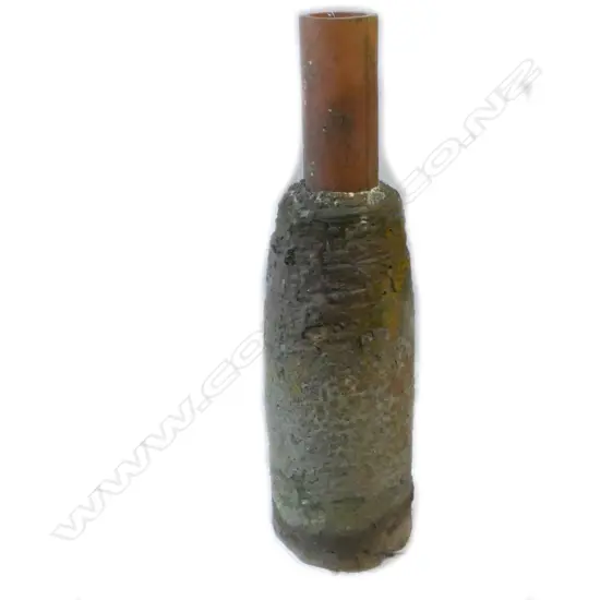 A large old upturned furnace crucible