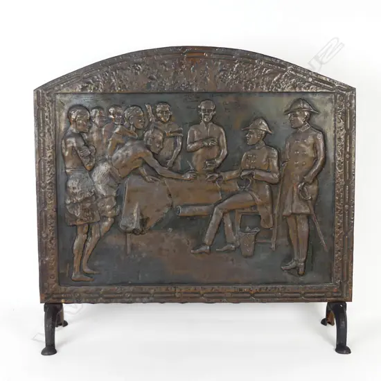 A vintage copper fire screen