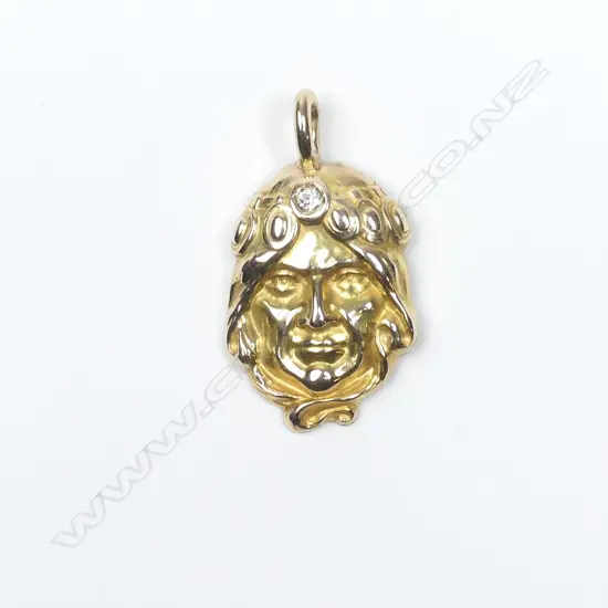 A 14ct gold Art Nouveau pendant as the head of a woman