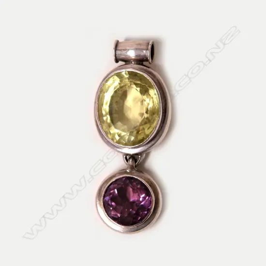 A large yellow-green beryl amethyst and silver pendant