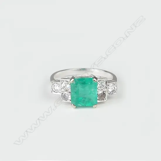 An 18ct white gold emerald and diamond Art Deco style ring