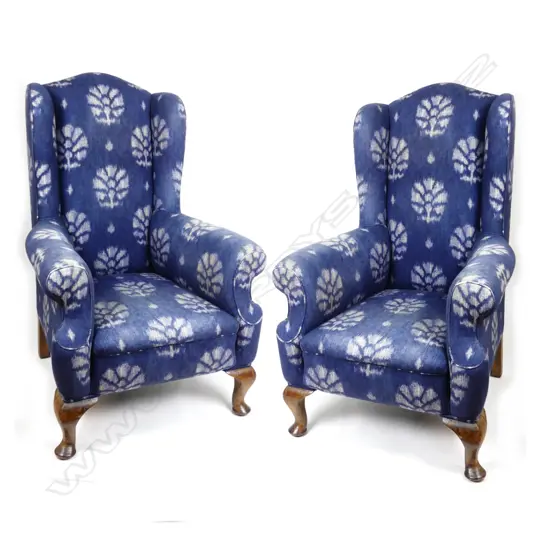 A pair of George II style wing back armchairs