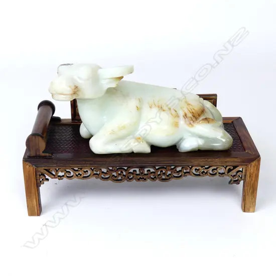 A Chinese carved jade recumbent bull