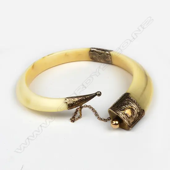 A large colonial 9ct gold and boar’s tusk bangle