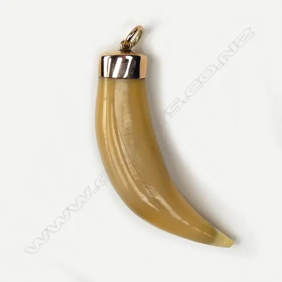 A vintage 9ct rose gold and lion's tooth pendant