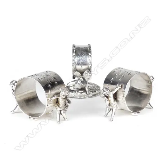 A pair plus one late 19thC American silver plate figured napkin rings