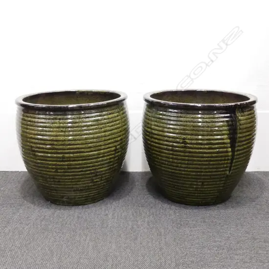 A pair of large mottled green and black glazed garden pots