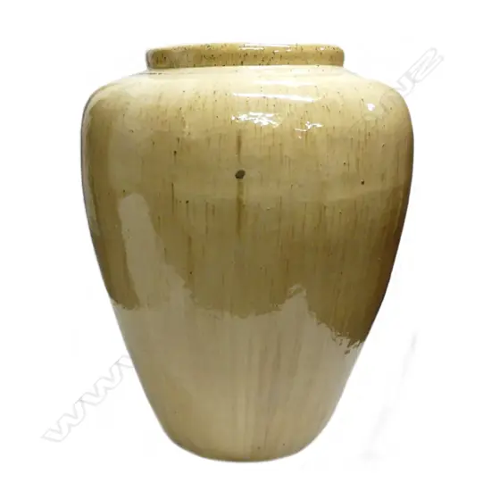 A large variable pale tan glossy glazed jar