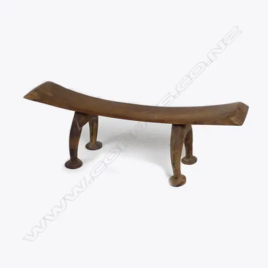 A Tongan Kali head rest with arched legs and pad feet