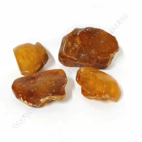 Four pieces of polished kauri gum