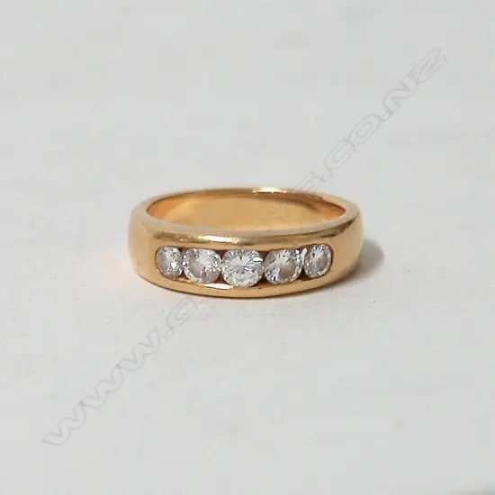 A heavy lady's 18ct. five stone diamond ring